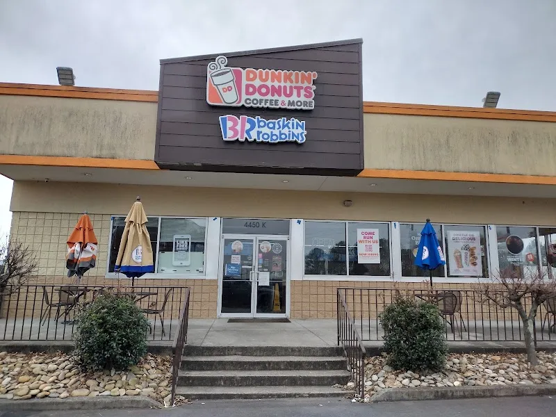 Dunkin Donuts and Baskin Robbins storefront with outdoor seating and steps