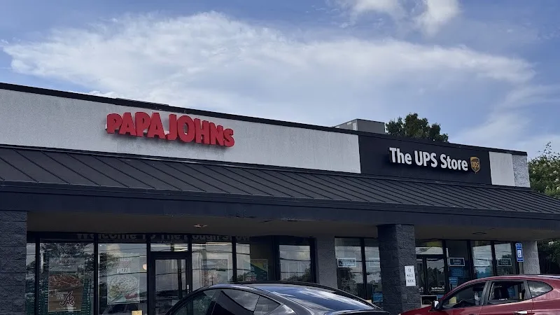 Papa Johns and The UPS Store storefronts in a strip mall