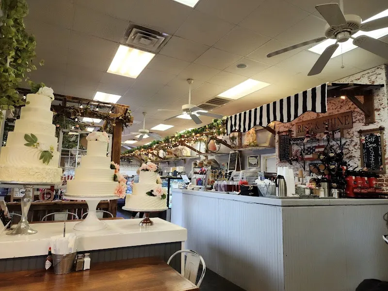 Bakery cafe interior with elegant white wedding cakes and coffee service counter